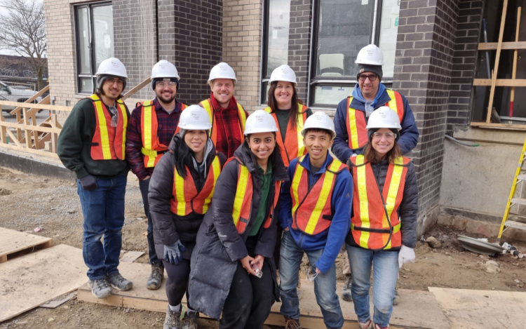 Team of ecobee Employees Wearing Hard Hats During a Volunteer Building Project for Habitat for Humanity.