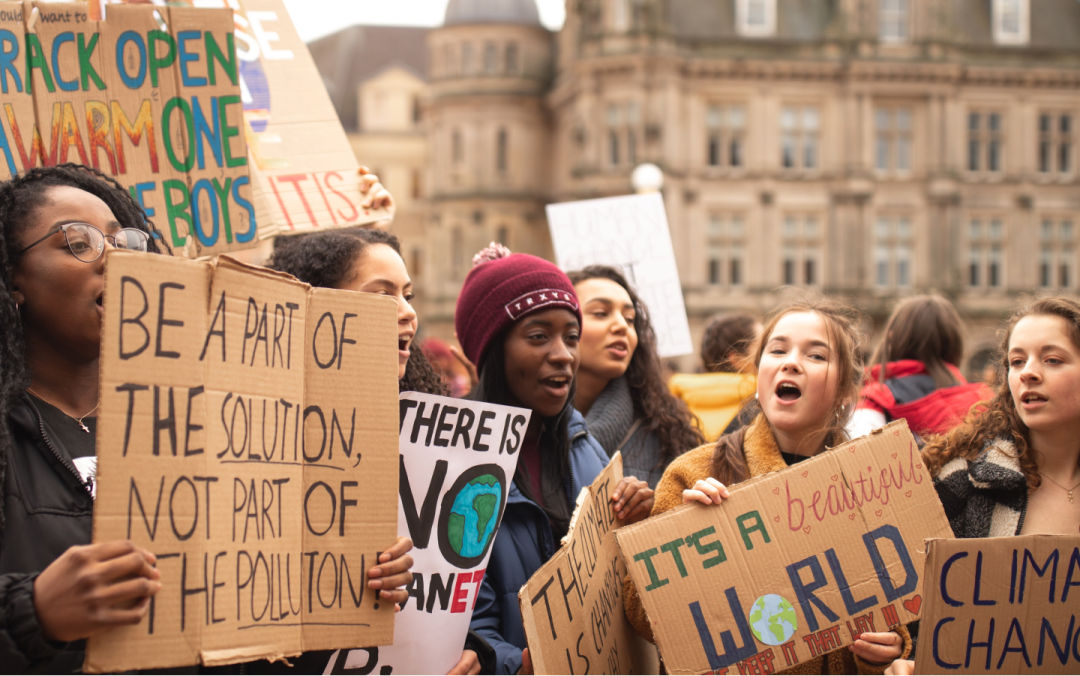 Youth with signs at a climate march.