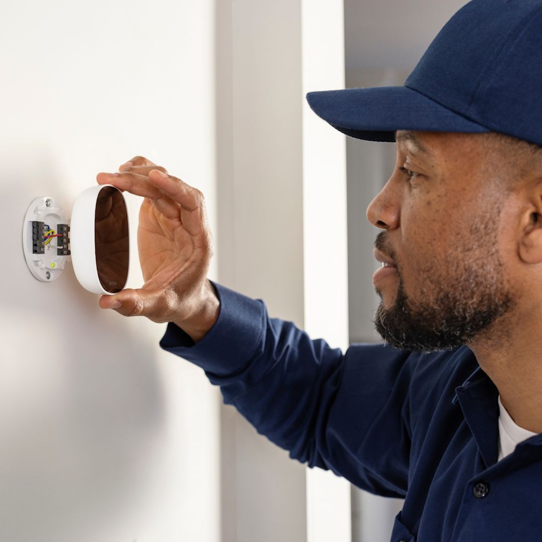 A technician installs an ecobee thermostat