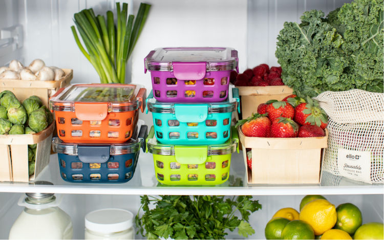 Highly organized fridge with separate containers for different fruits and vegetables.