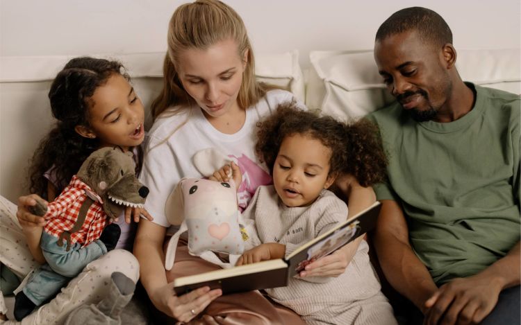 A family seated on the sofa and spending quality time together