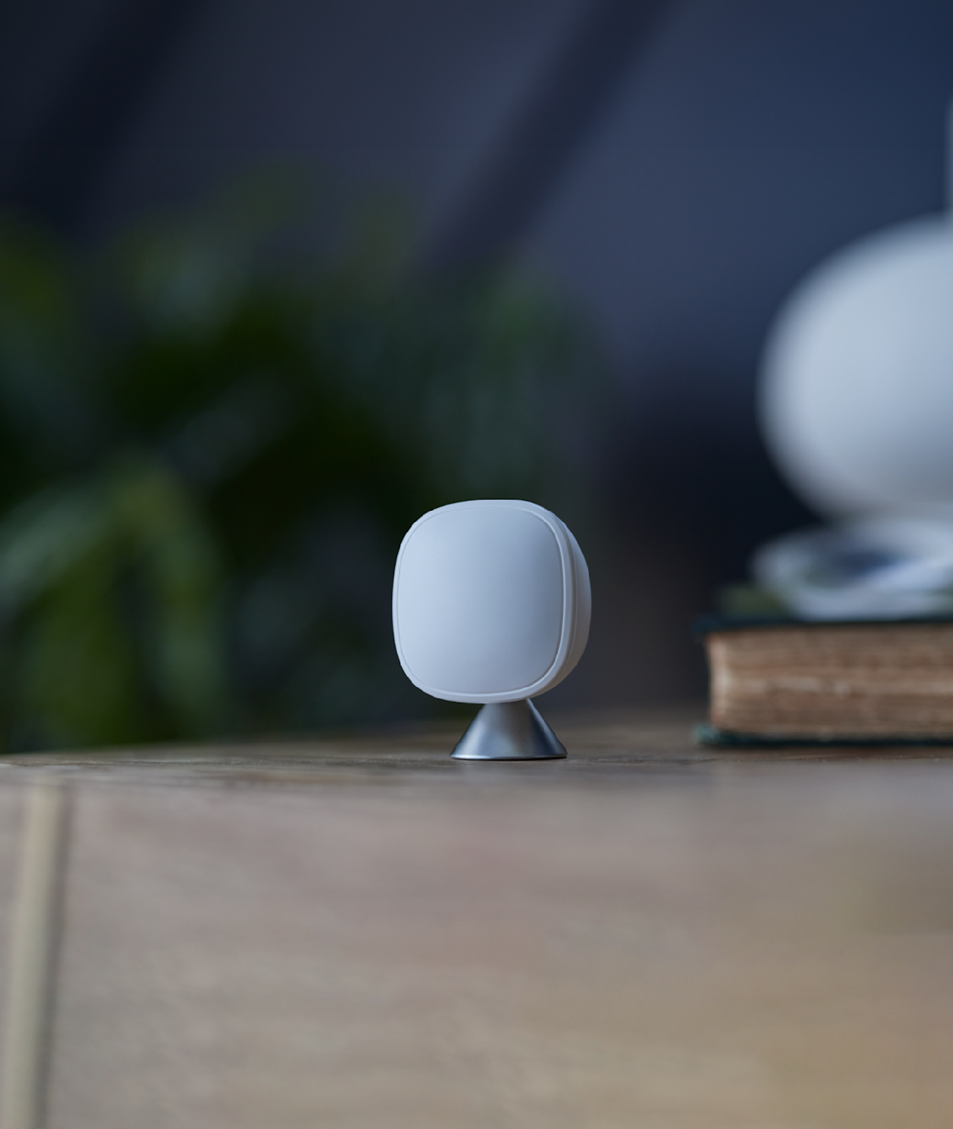 A single Smart Sensor rests on a wooden surface