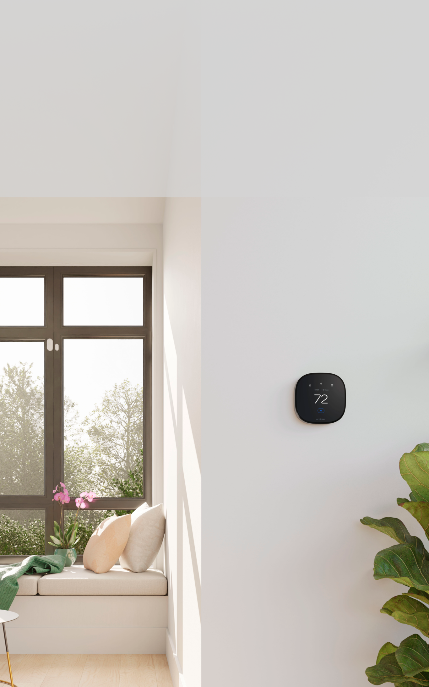 ecobee thermostat on a wall; a window showing a bright sunny day is nearby with an ecobee smartsensor for doors & windows