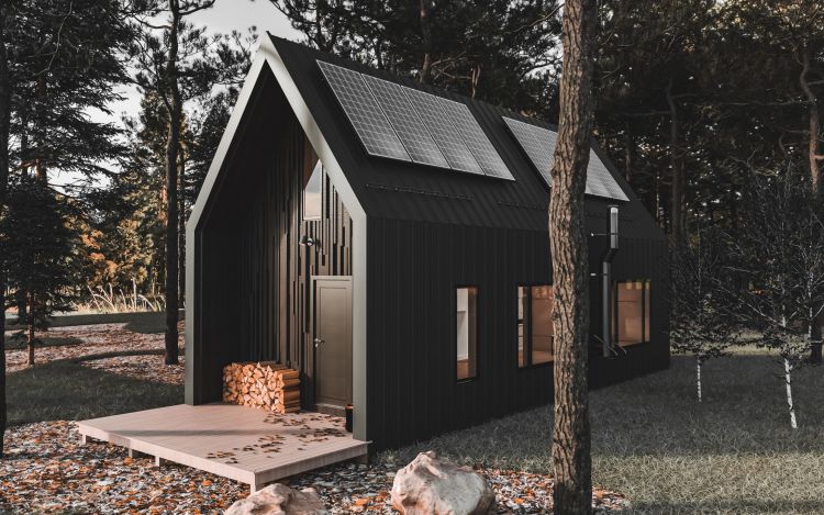 A dark tiny home with solar panels on the roof