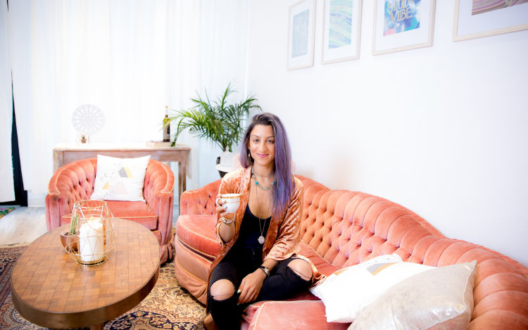 Vanessa Vakharia, the founder and director of The Math Guru sitting on a vintage salmon-colored chesterfield sipping tea at home in midtown Toronto. Vanessa shared her thoughts with us on creating a tranquil co-working space for parents and kids. 