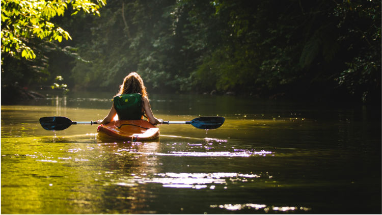 Girl kayaking in the lake.