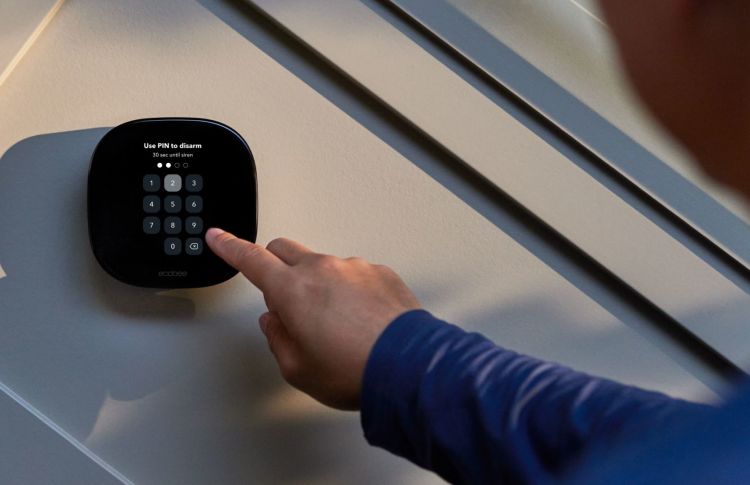 Person disarming ecobee Smart Security with pin on thermostat keypad. 