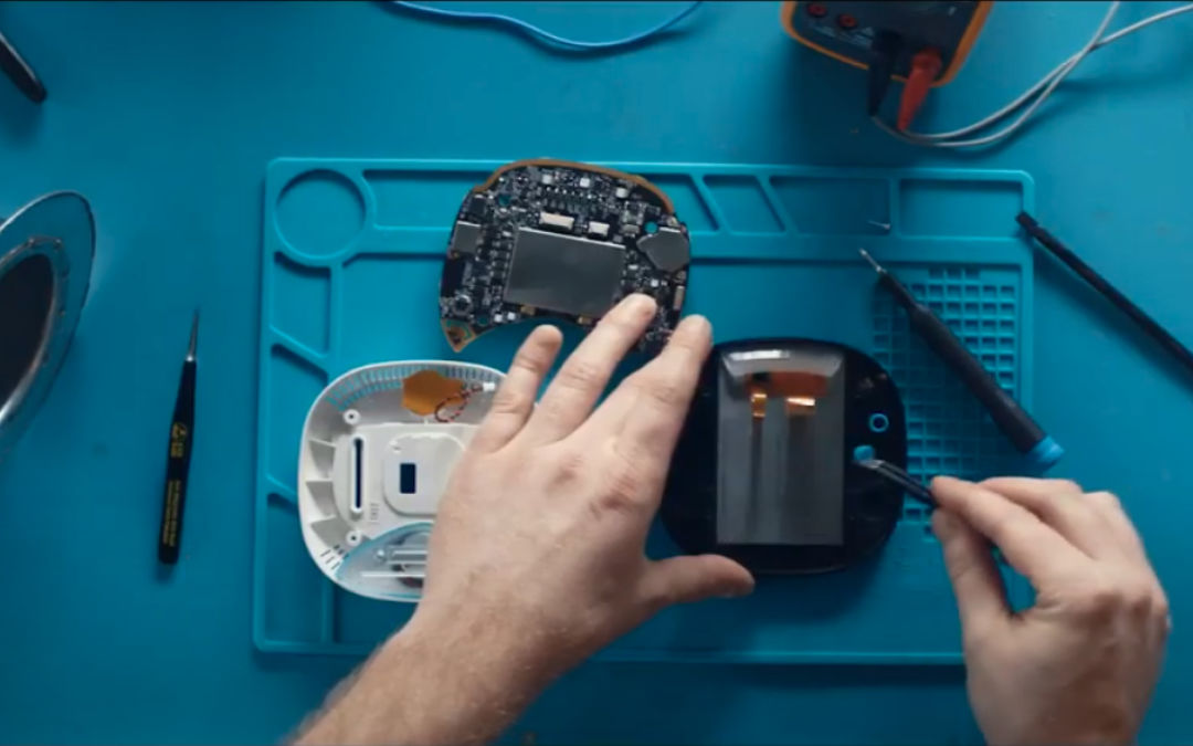 Close-up of person assembling an ecobee thermostat.