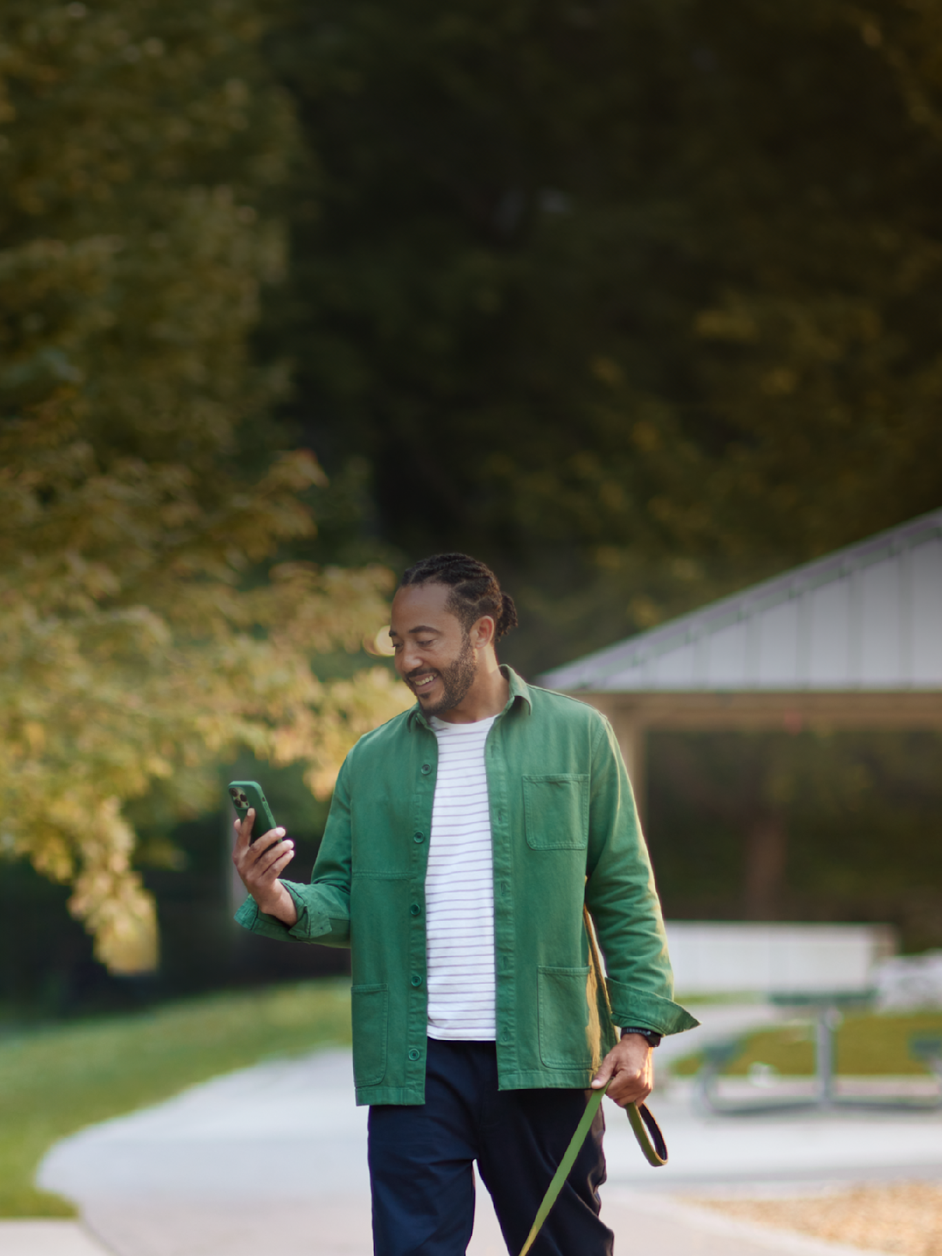 a man looks at his phone while outside