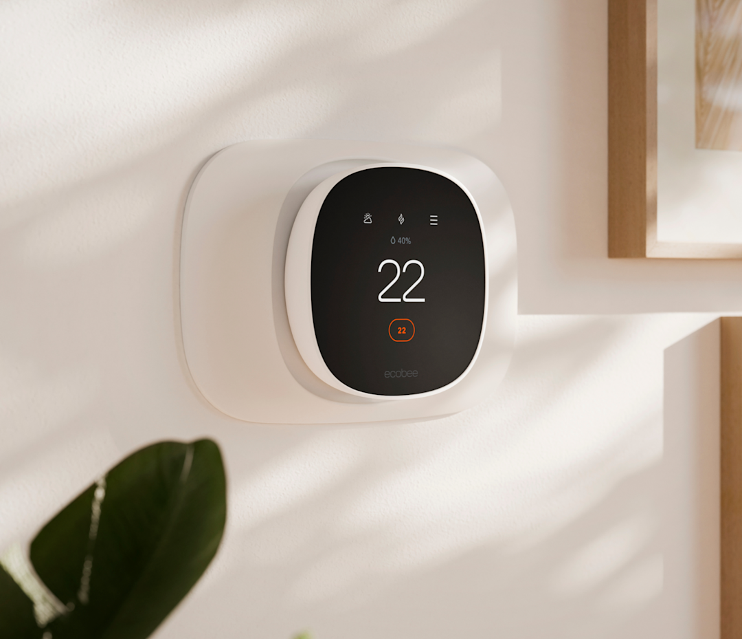 ecobee smart thermostat essential with a trim plate on a wall
