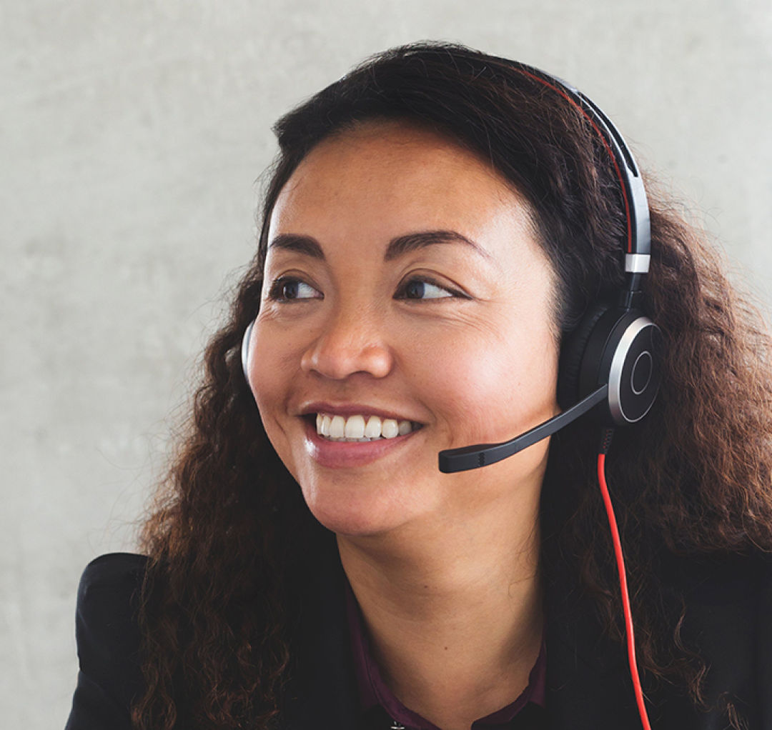 Woman smiling with a headset.