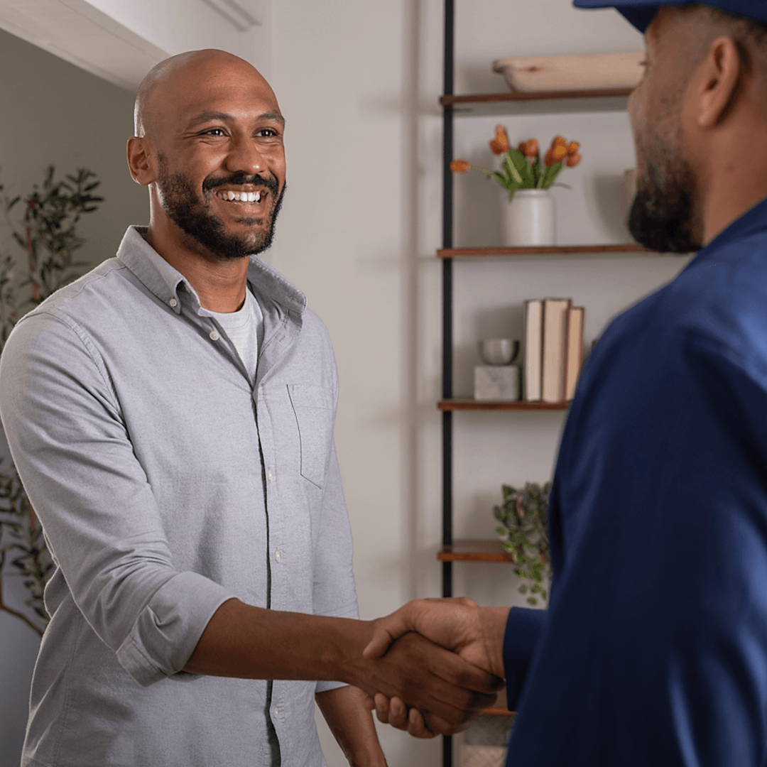 man shakes hands with an hvac technician