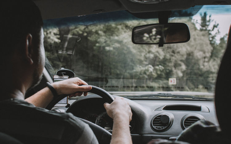 An interior view of a man driving a car.