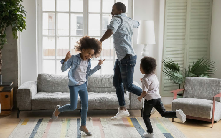 A family dance around a living room.