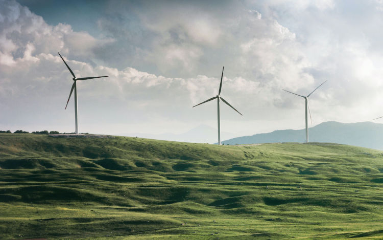 Landscape image of wind turbines in action