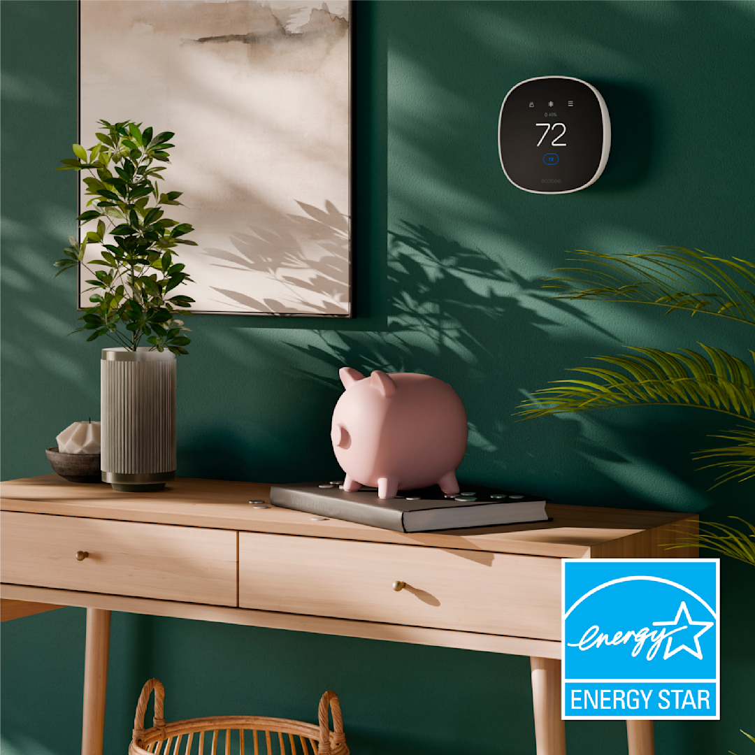 ecobee smart thermostat essential on a wall next to a piggy bank