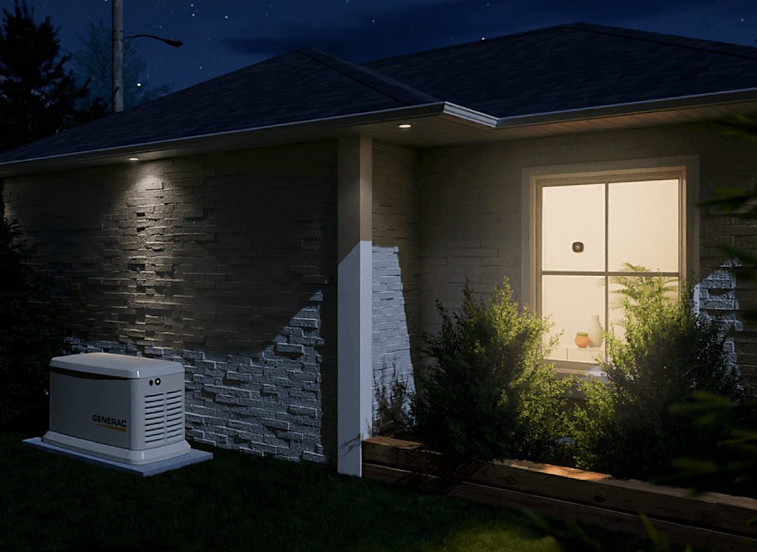 outside of a house at night with a generac generator, there are lights on inside that show an ecobee thermostat