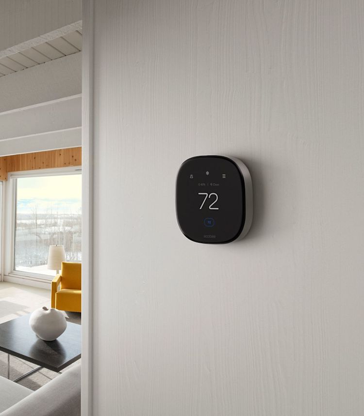 ecobee's Smart Thermostat Premium installed on a white wall in a modern home with clean lines.