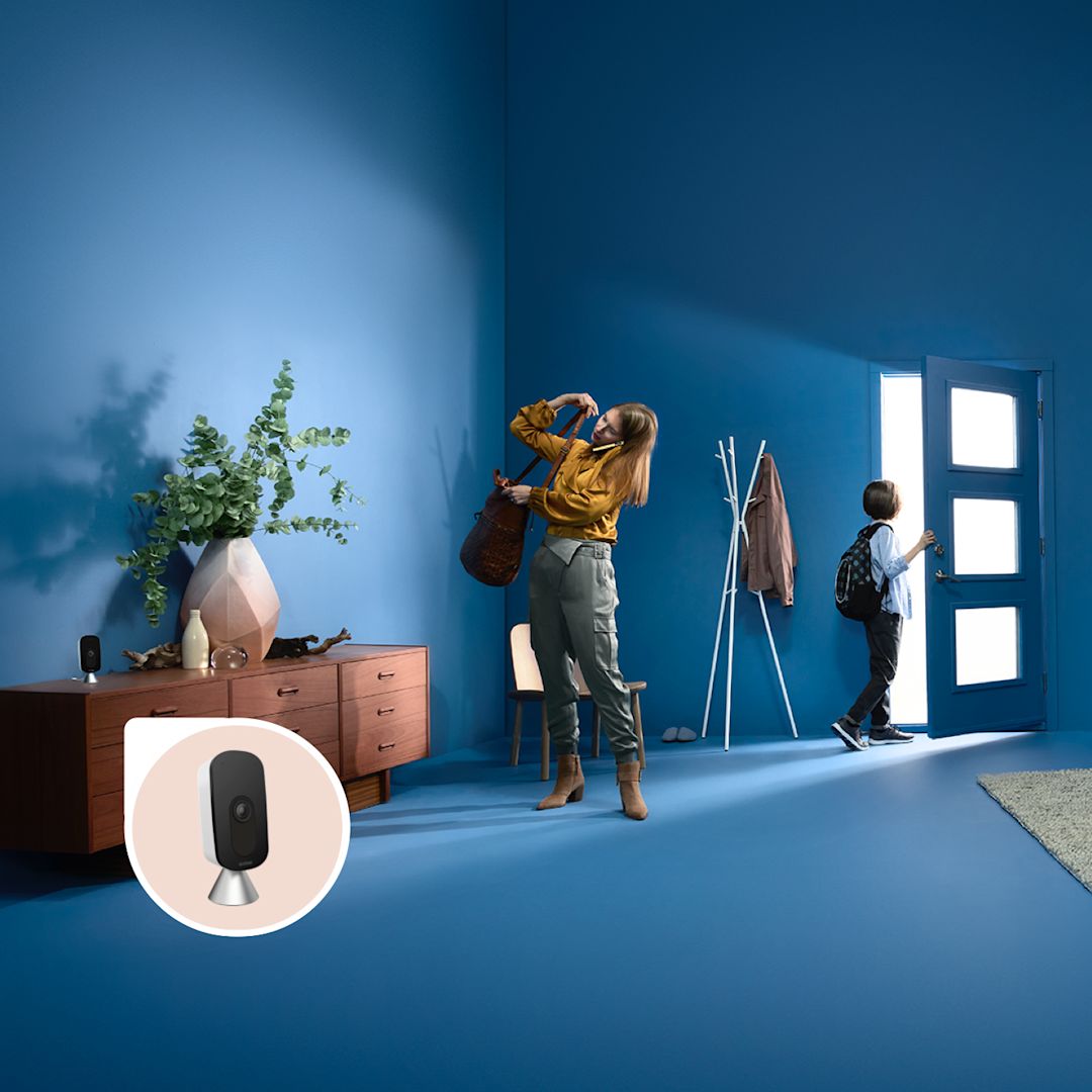 A woman and her child get ready to leave the house while the ecobee SmartCamera keeps watch.