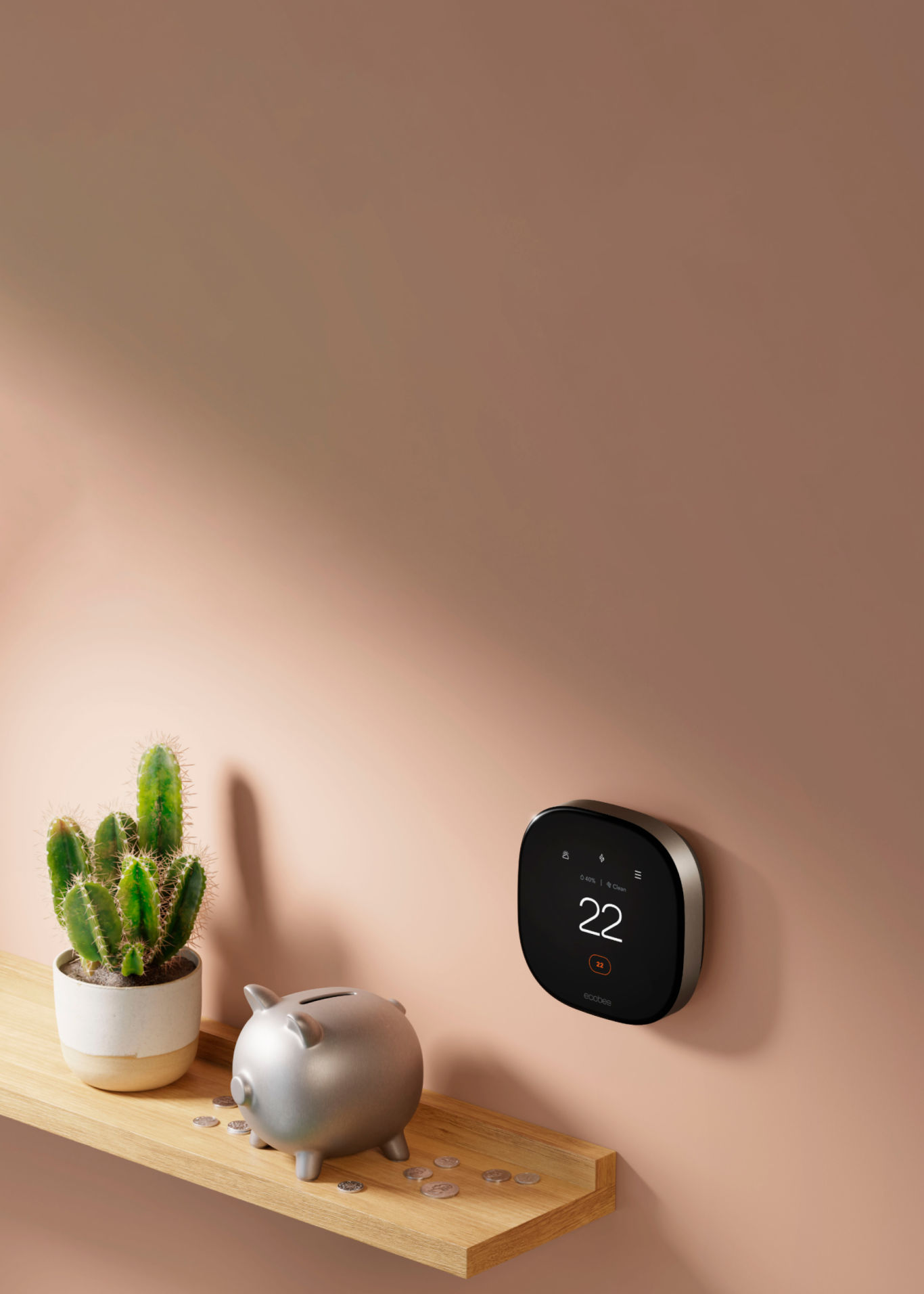 ecobee thermostat on a wall next to a piggy bank on a shelf