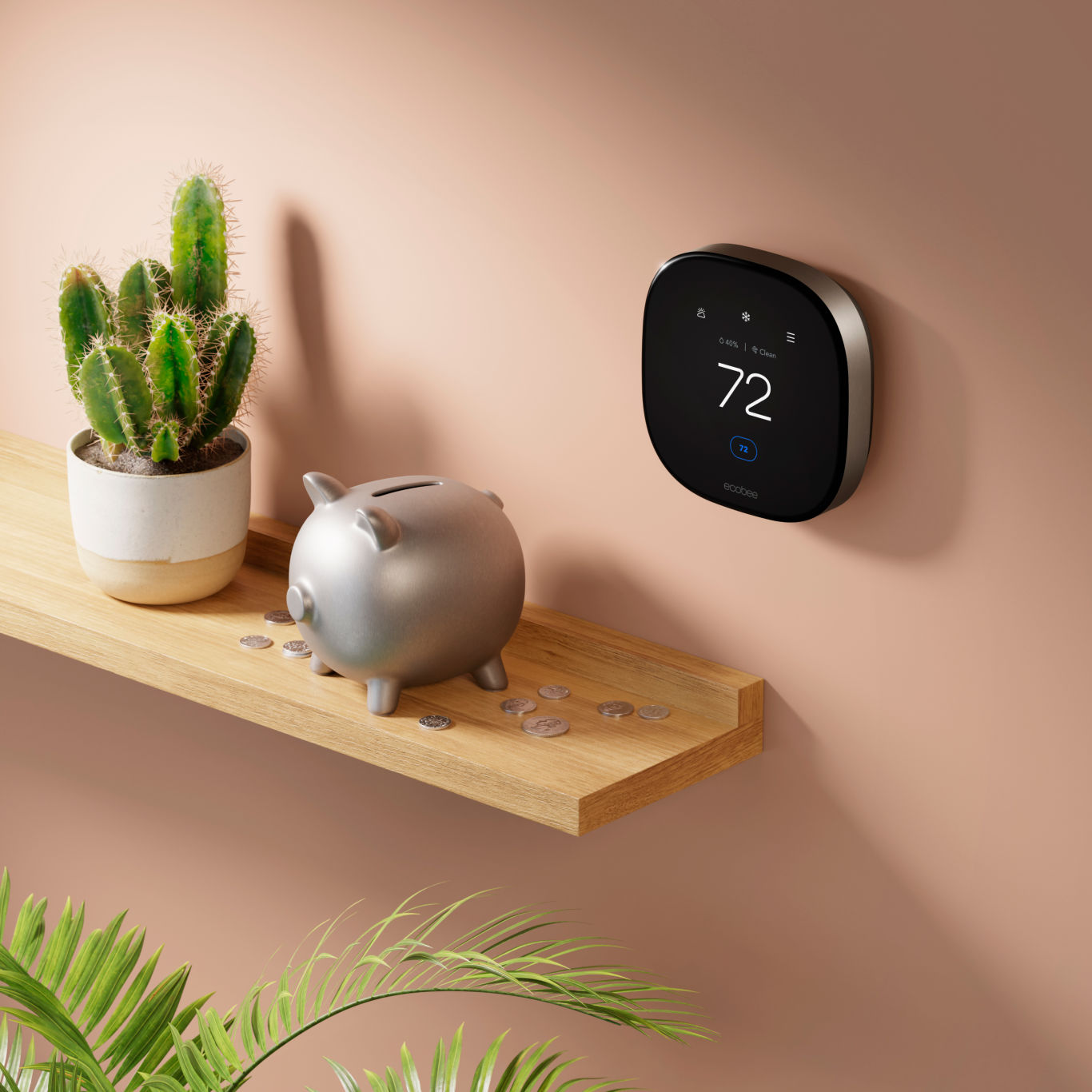 ecobee smart thermostat premium on a wall next to a shelf with a piggy bank and coins.