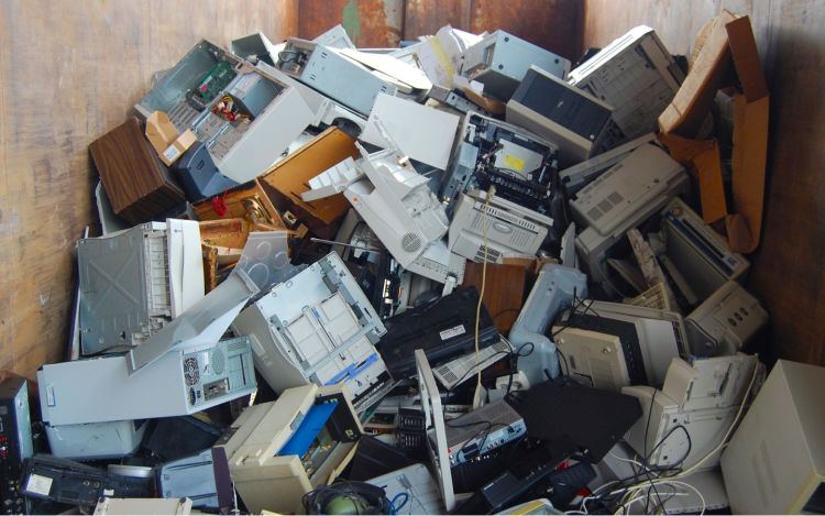Image of e-waste, with computer equipment piled up. 