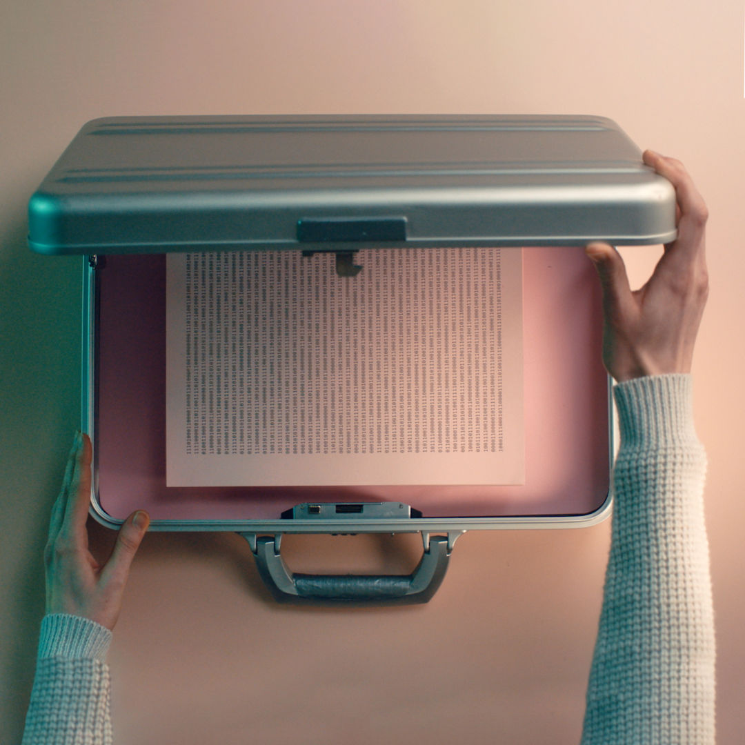 Privacy secured with woman closing a briefcase over sensitive print data.