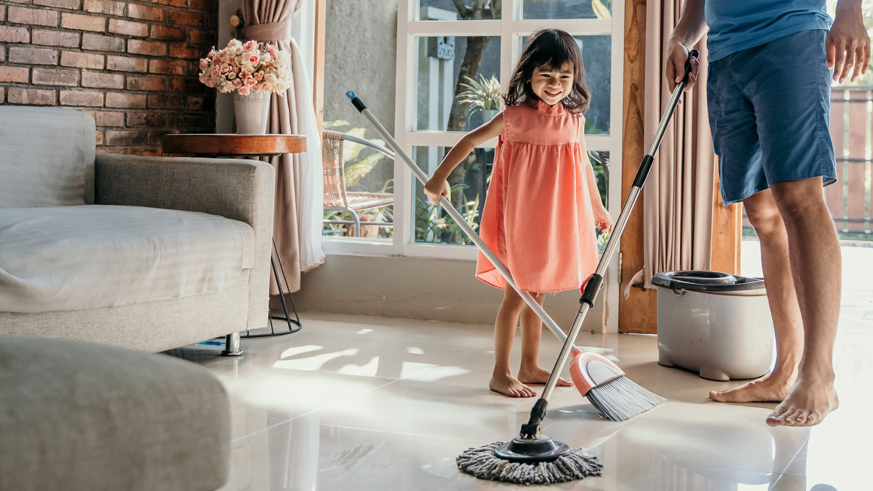 Image of family mopping and sweeping.