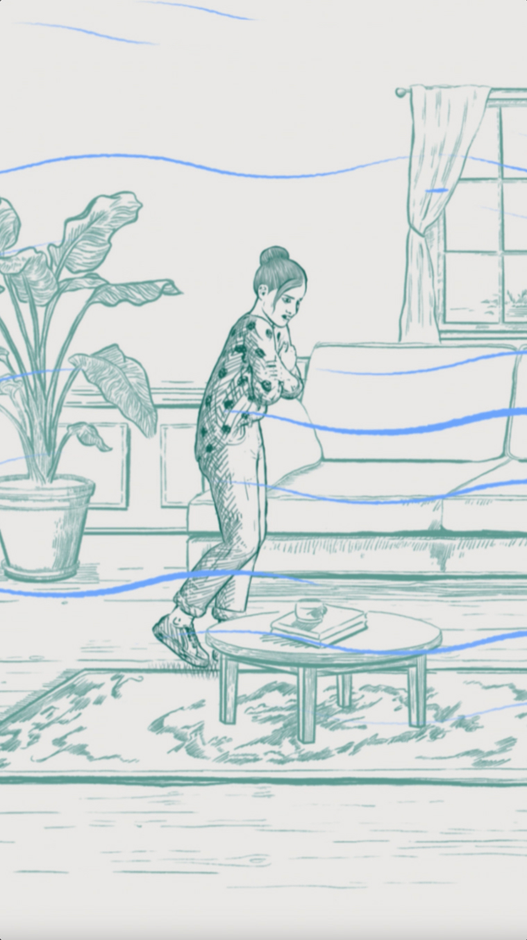 A woman walking through her living room and shivering because it is too cold.