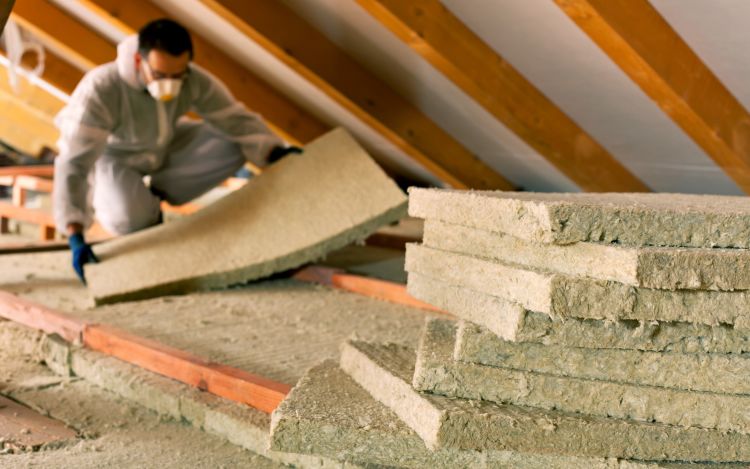 Professional contractor adding insulation to attic