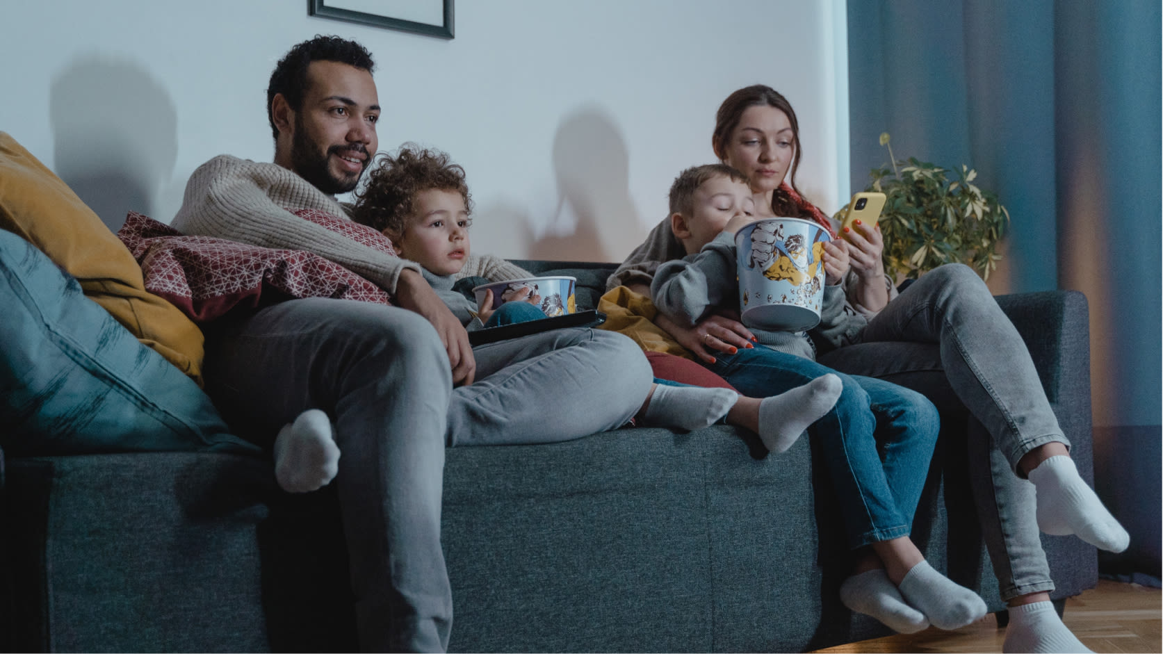 Family gathering around to watch a movie.