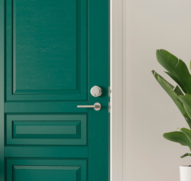 A green door with a smart lock