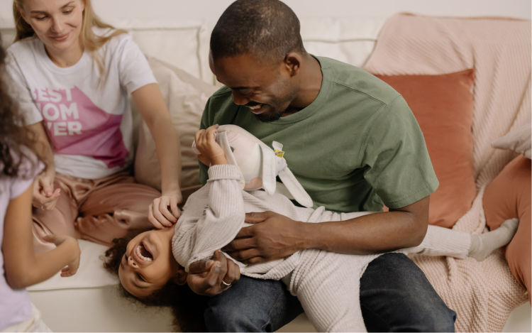 Father and mother having fun with two kids.