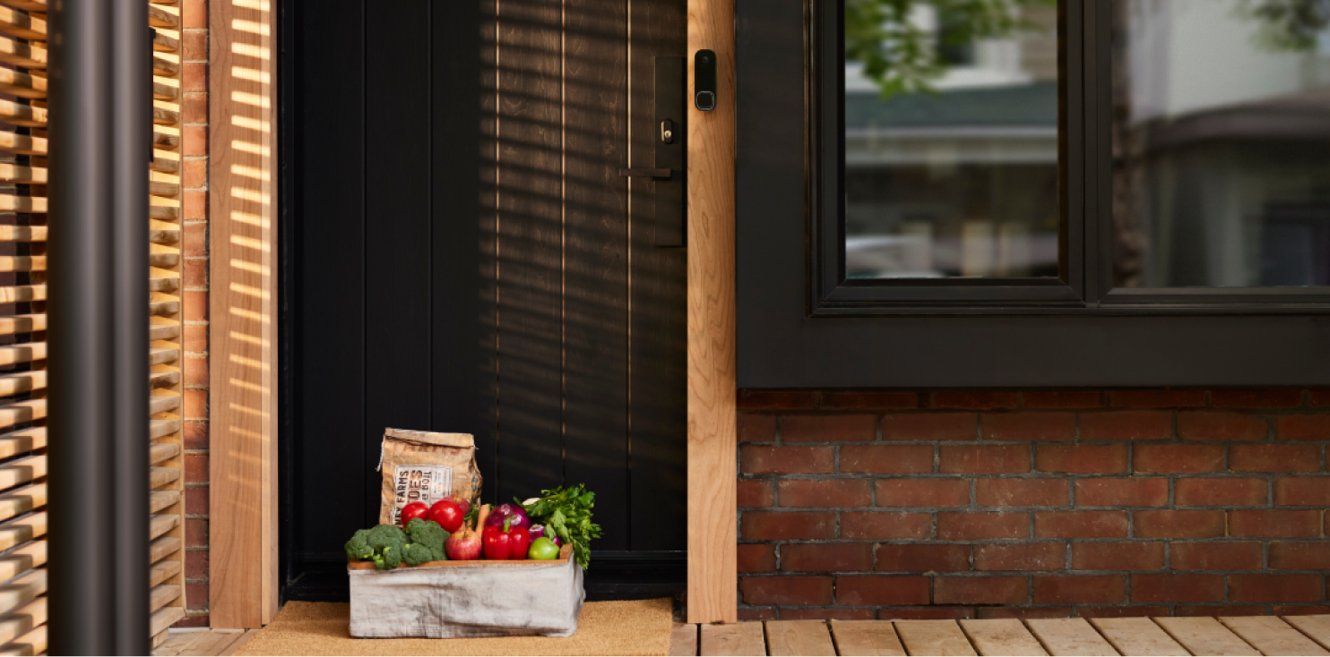 a package on a front step with the ecobee smart doorbell camera next to the door