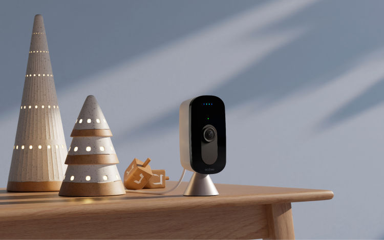 ecobee SmartCamera placed on a table together with a few Christmas ornaments