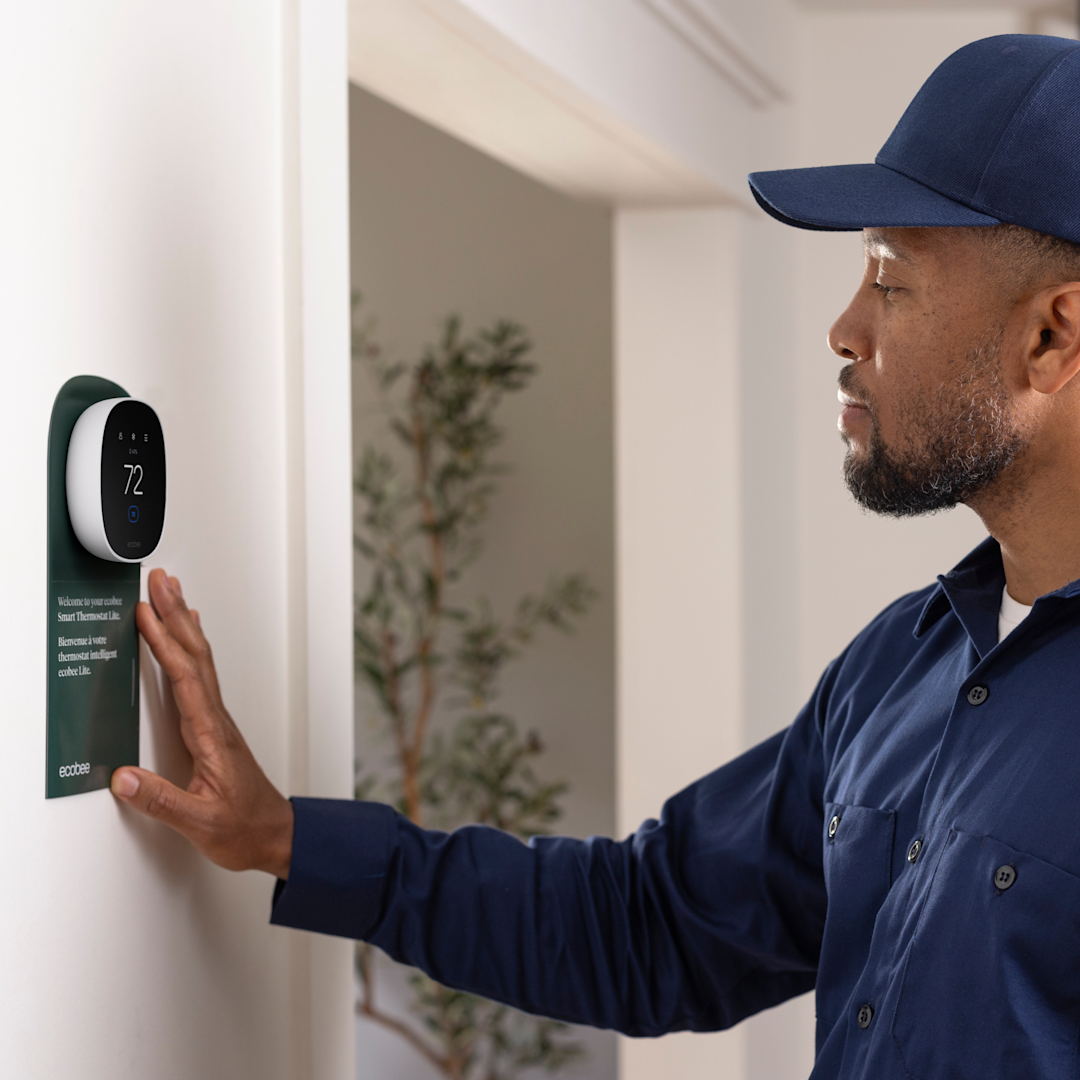 hvac technician installs an ecobee thermostat