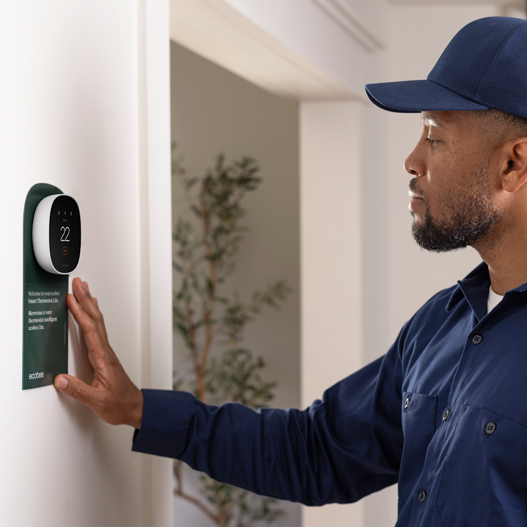 hvac technician installs an ecobee thermostat
