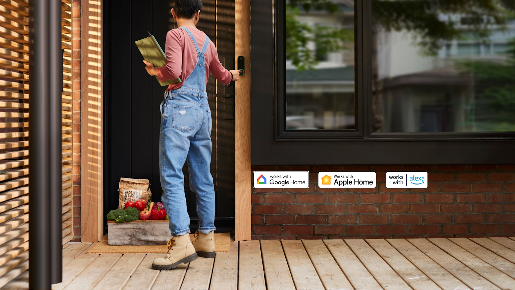 A front door of a house with ecobee's Smart Doorbell Camera visible while a person is pressing the doorbell while making a fresh food delivery.