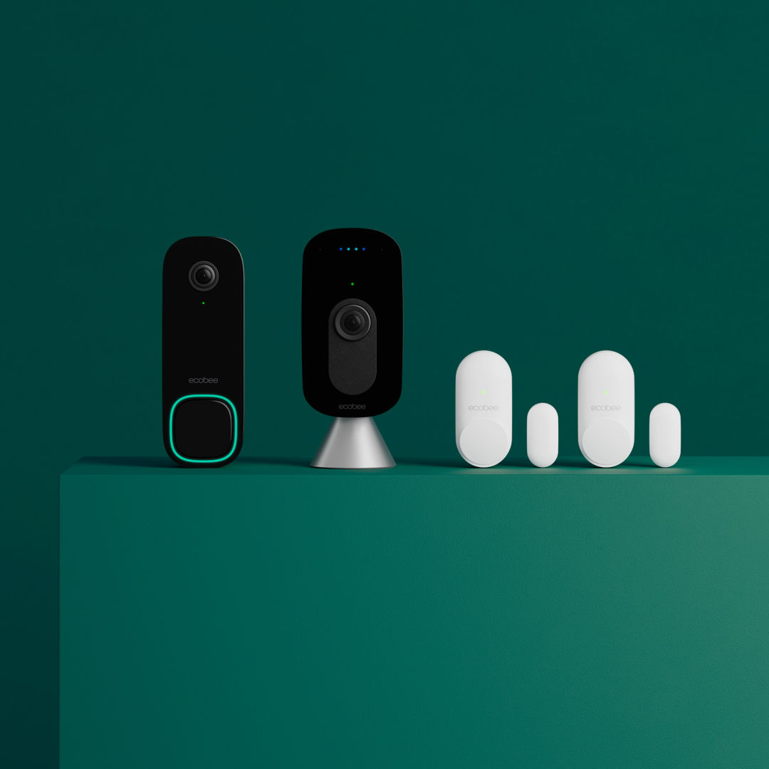 Smart Doorbell (wired), SmartCamera with voice control and a pair of SmartSenor for doors and windows displayed in a row on a green background. 
