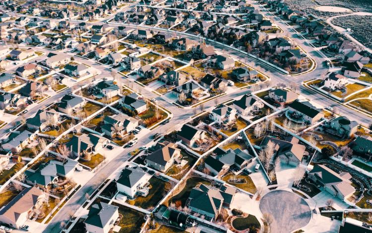 An aerial shot of a city, where many rsidential homes can be seen