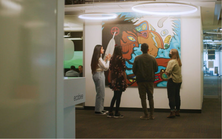 ecobee employees stopping to admire new artwork by Philip Cote. 