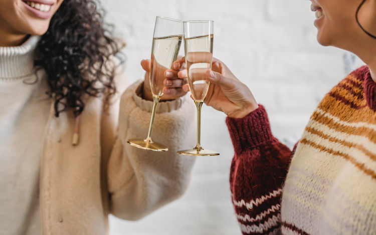 Two people toasting with champagne.