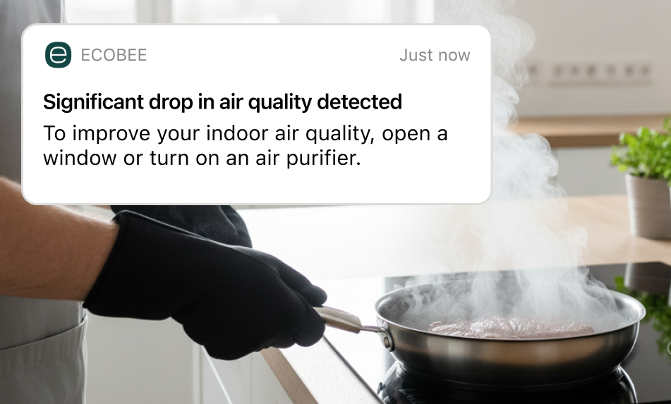 Person cooking in the kitchen with smoke emanating from food on a stovetop pan; a notification from the ecobee app says "Significant drop in air quality"