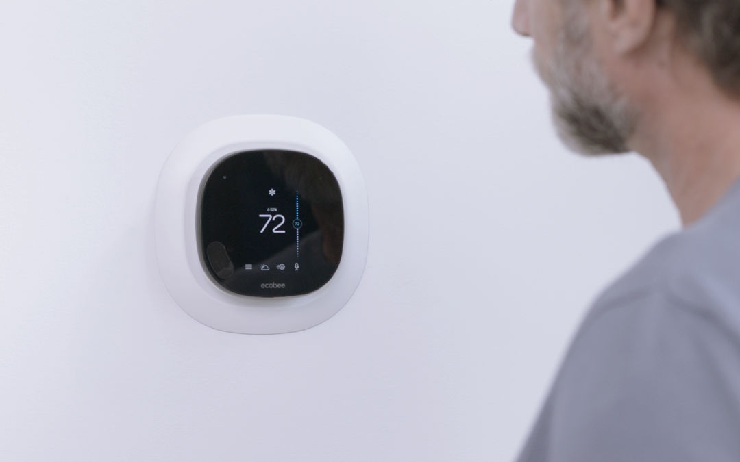 Homeowner checking temperature on his ecobee thermostat. Feels Like uses the humidity sensor on ecobee smart thermostats to ensure the indoor temperature always feels like the temperature set on your thermostat.