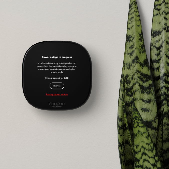ecobee thermostat on a wall, the screen says "power outage in progress"
