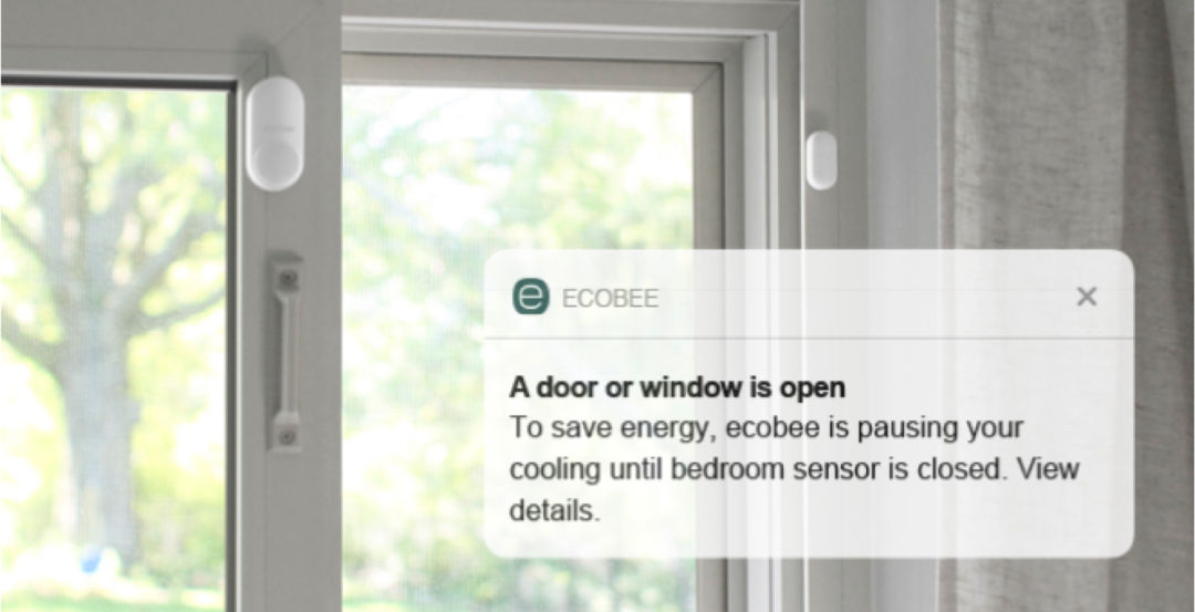 ecobee SmartSensors on a door, with a notification from the ecobee app saying a door or window is open.