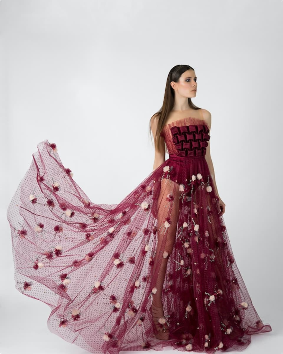 A person wearing a maroon coloured flowing dress