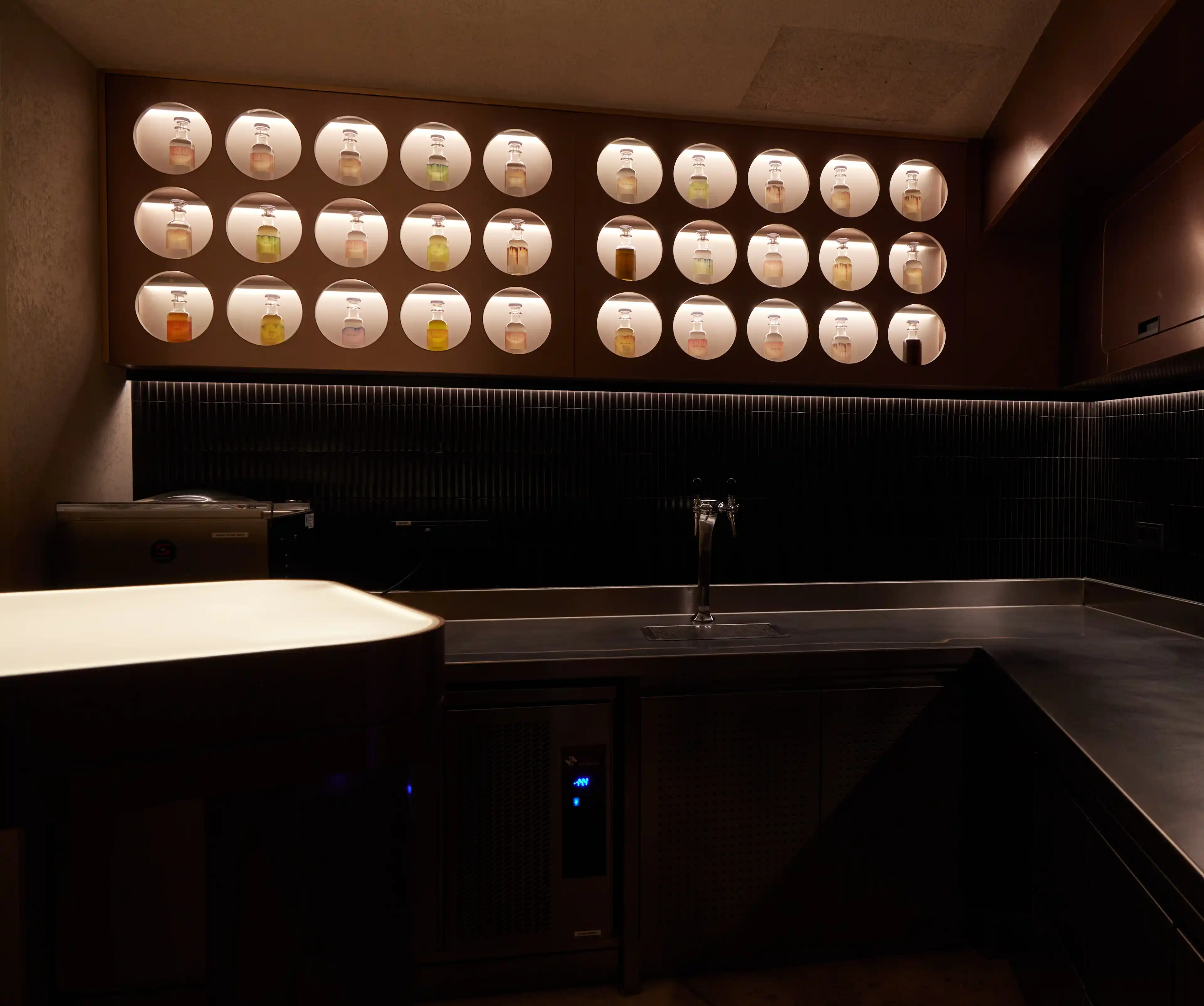 Backwall of the bar. Beautifully lit with bottles on display.