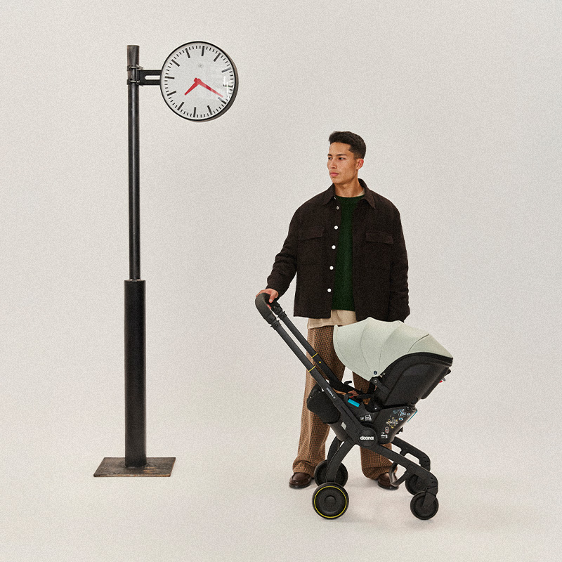 Parent running errands with Doona car seat stroller