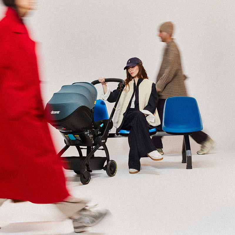 Parent with Doona stroller on public transit
